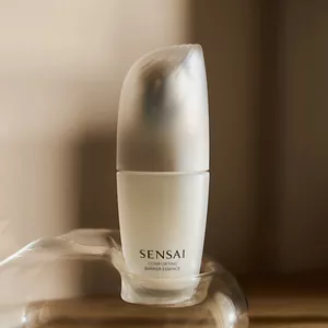 Comforting Barrier Essence bottle in summer mood lighting